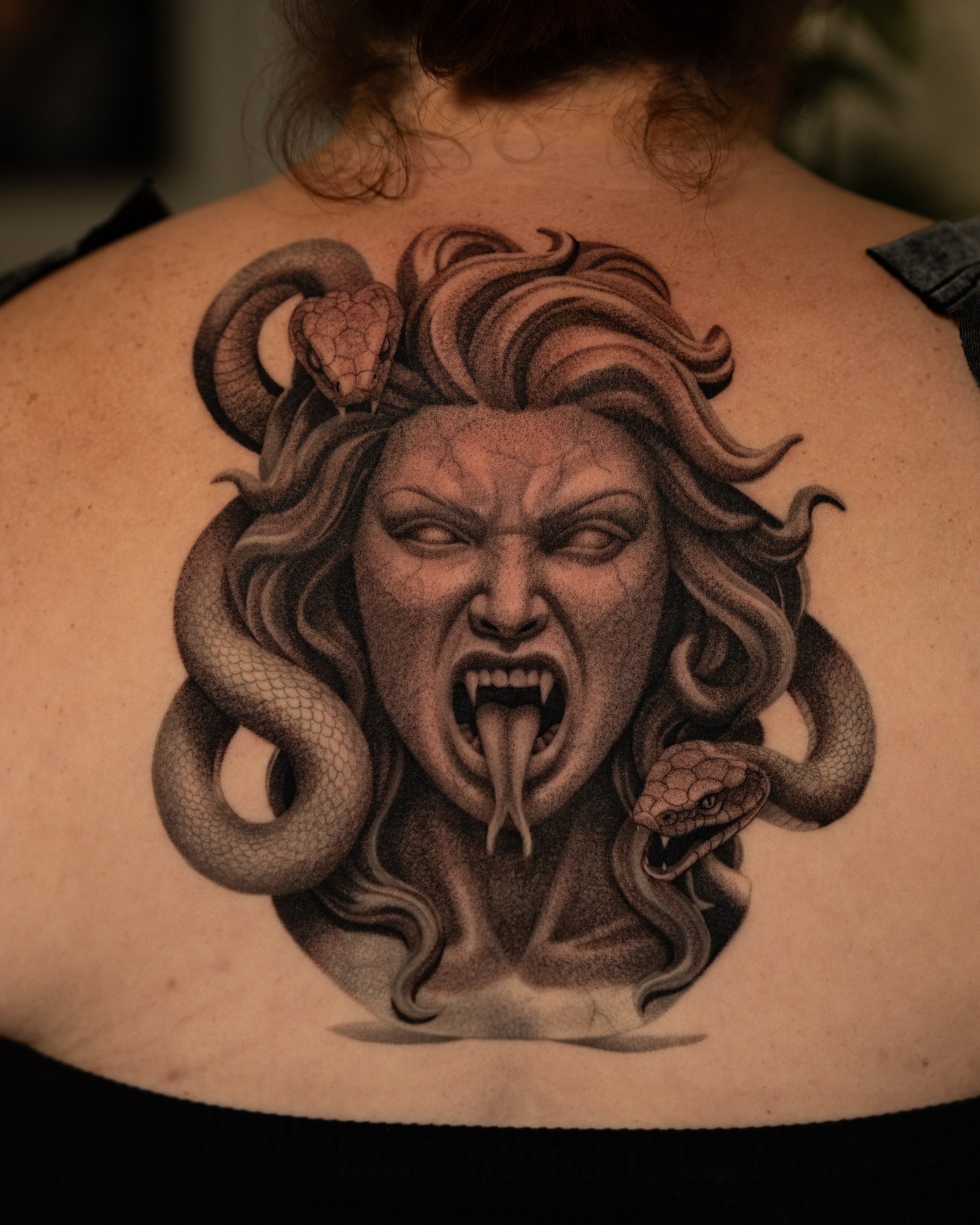 Medusa with snakes upper-back tattoo in black and grey realism by Jon LaFlore, Dallas TX